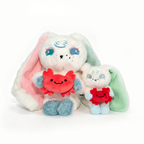 Two plush bunnies with pastel colors hold red crabs—unique Plushie Dreadfuls for a charming Cancer Zodiac Gift.