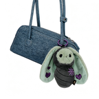 A blue purse with a cute Bunnculus Plush Keychain—a gray and mint bee sporting purple heart accents.