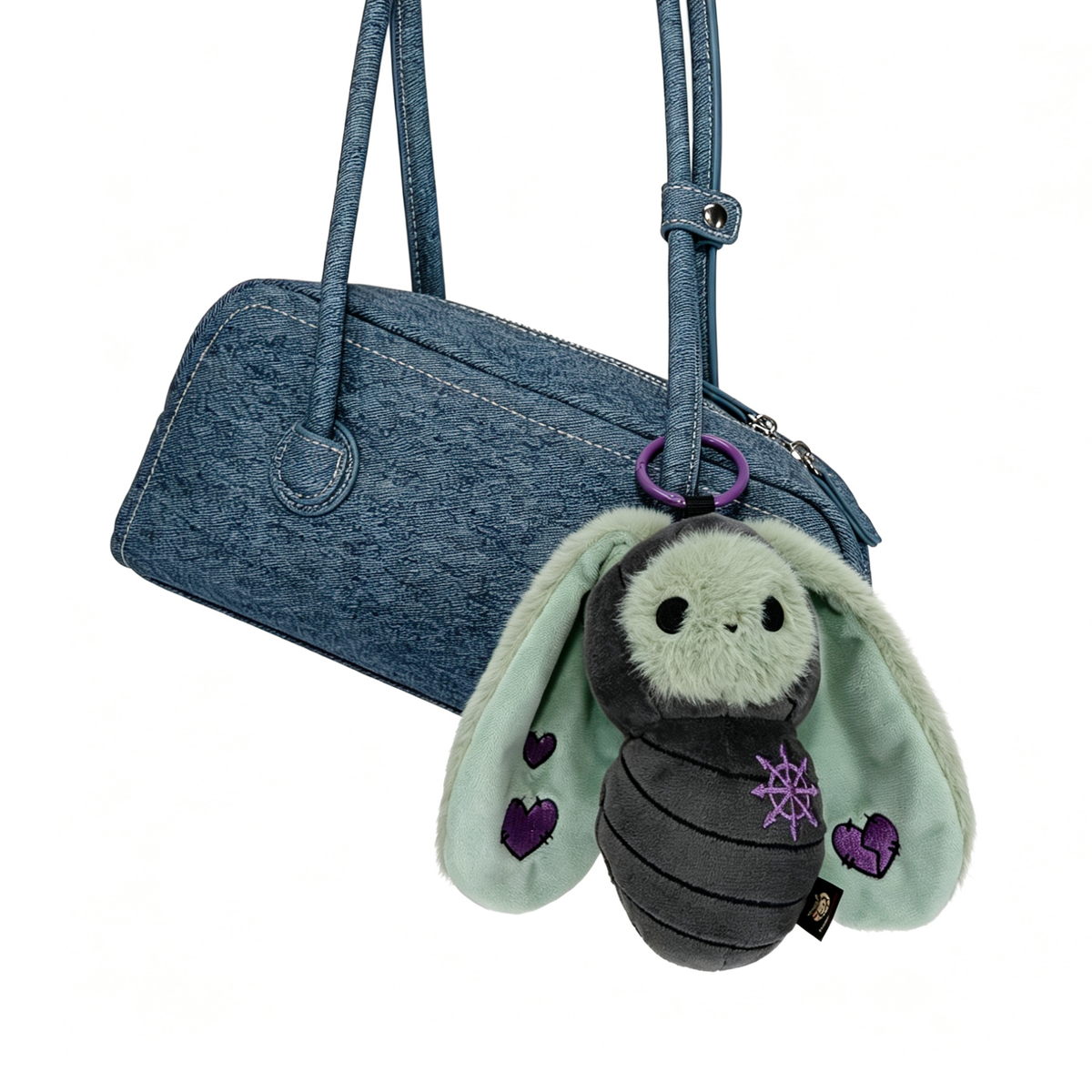 A blue purse with a cute Bunnculus Plush Keychain—a gray and mint bee sporting purple heart accents.