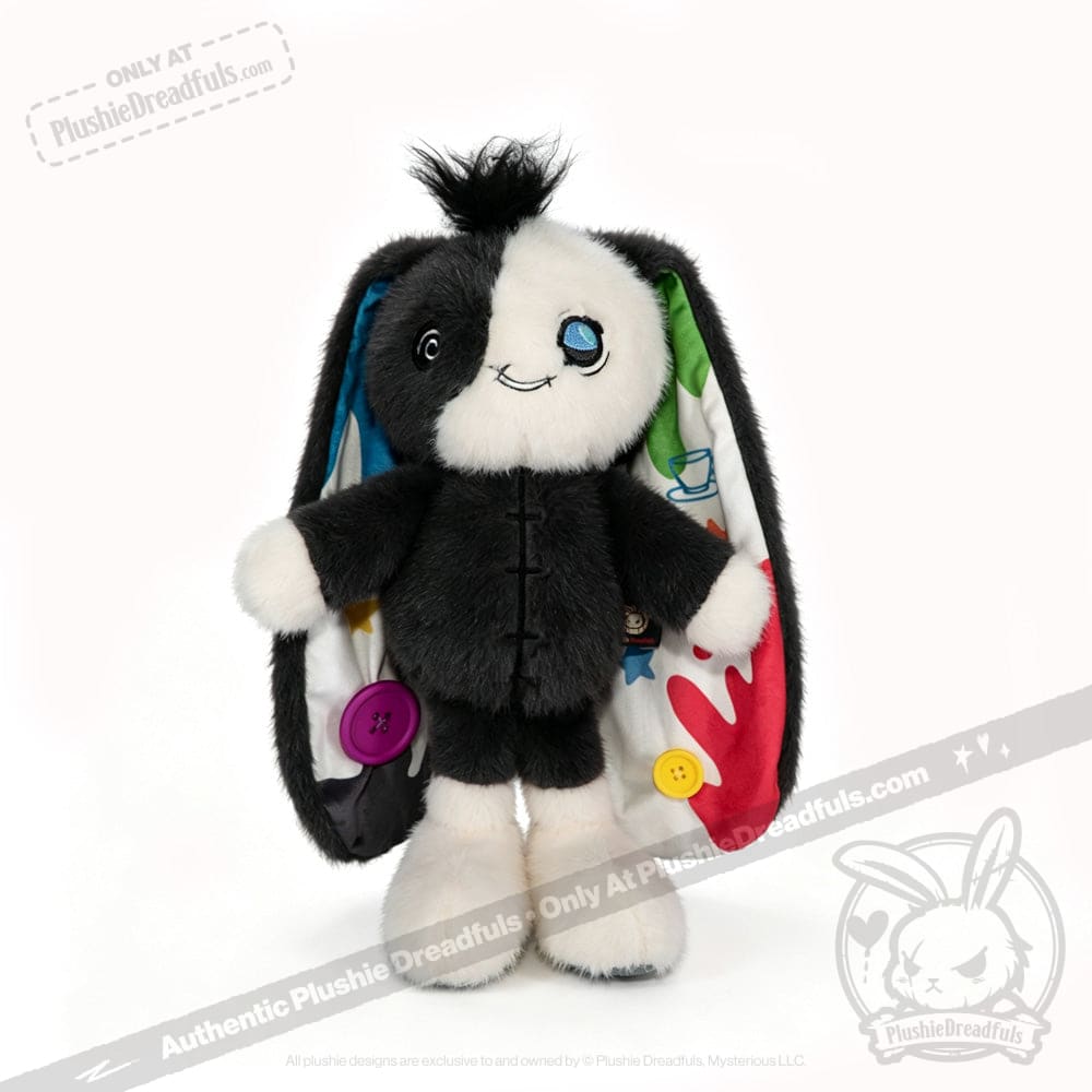 Quirky plushie bunny with mismatched buttons and colorful ears, embodying acceptance and Mad Hatter energy.