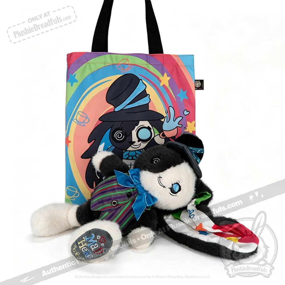 Plushie rabbit in a suit, inspired by the ADHD Mad Hatter, lies before a rainbow tote with matching cartoon design.